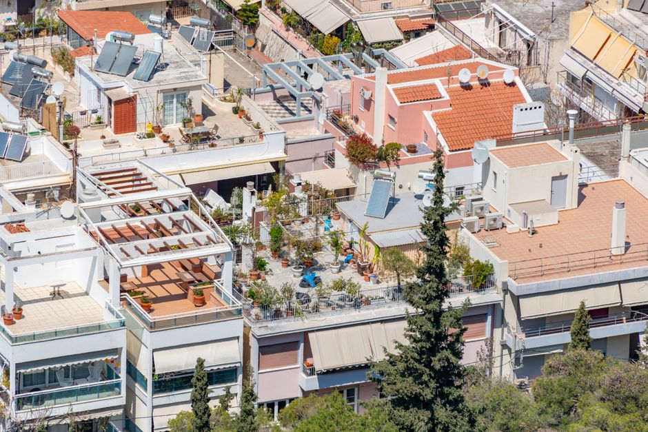 Top renewable energy ETFs — Vibrant urban rooftop gardens with solar panels in a residential district.